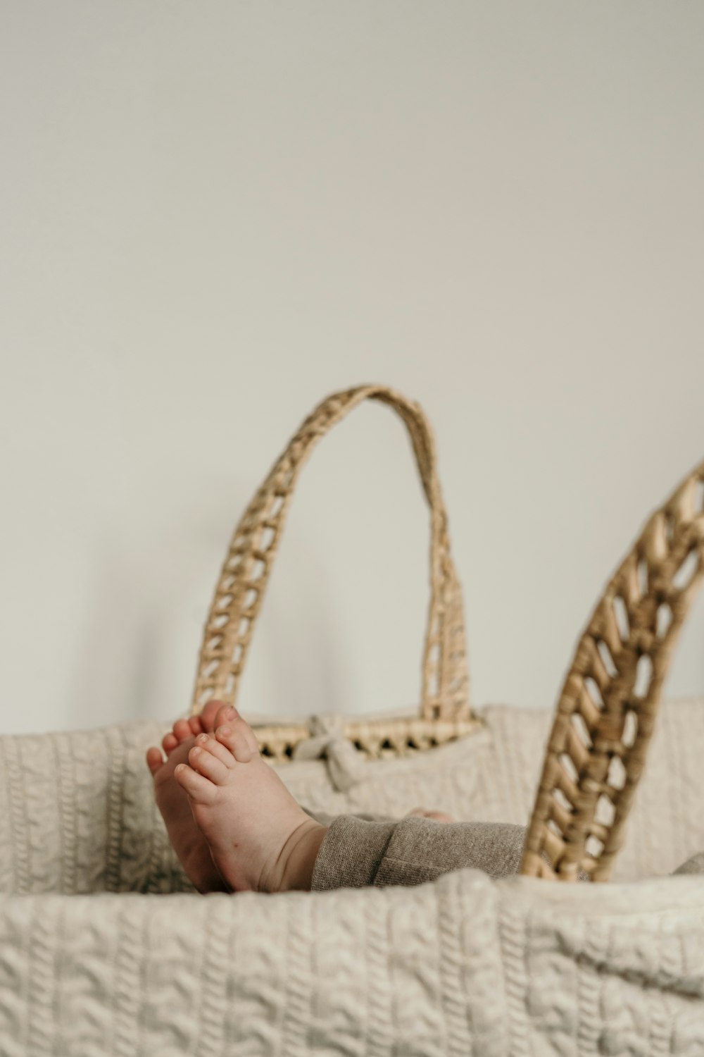 a person laying on a bed with a handbag