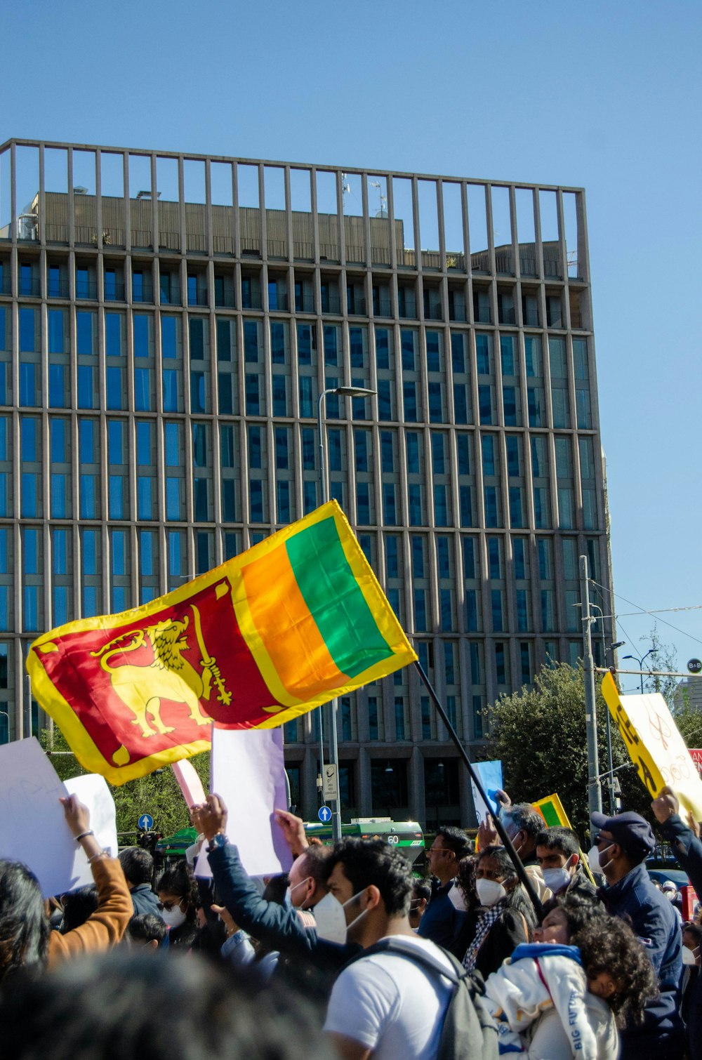 a group of people holding flags in front of a building