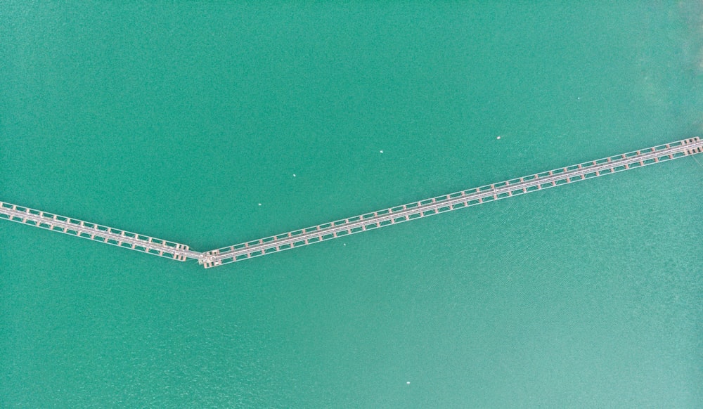 an aerial view of a bridge over a body of water