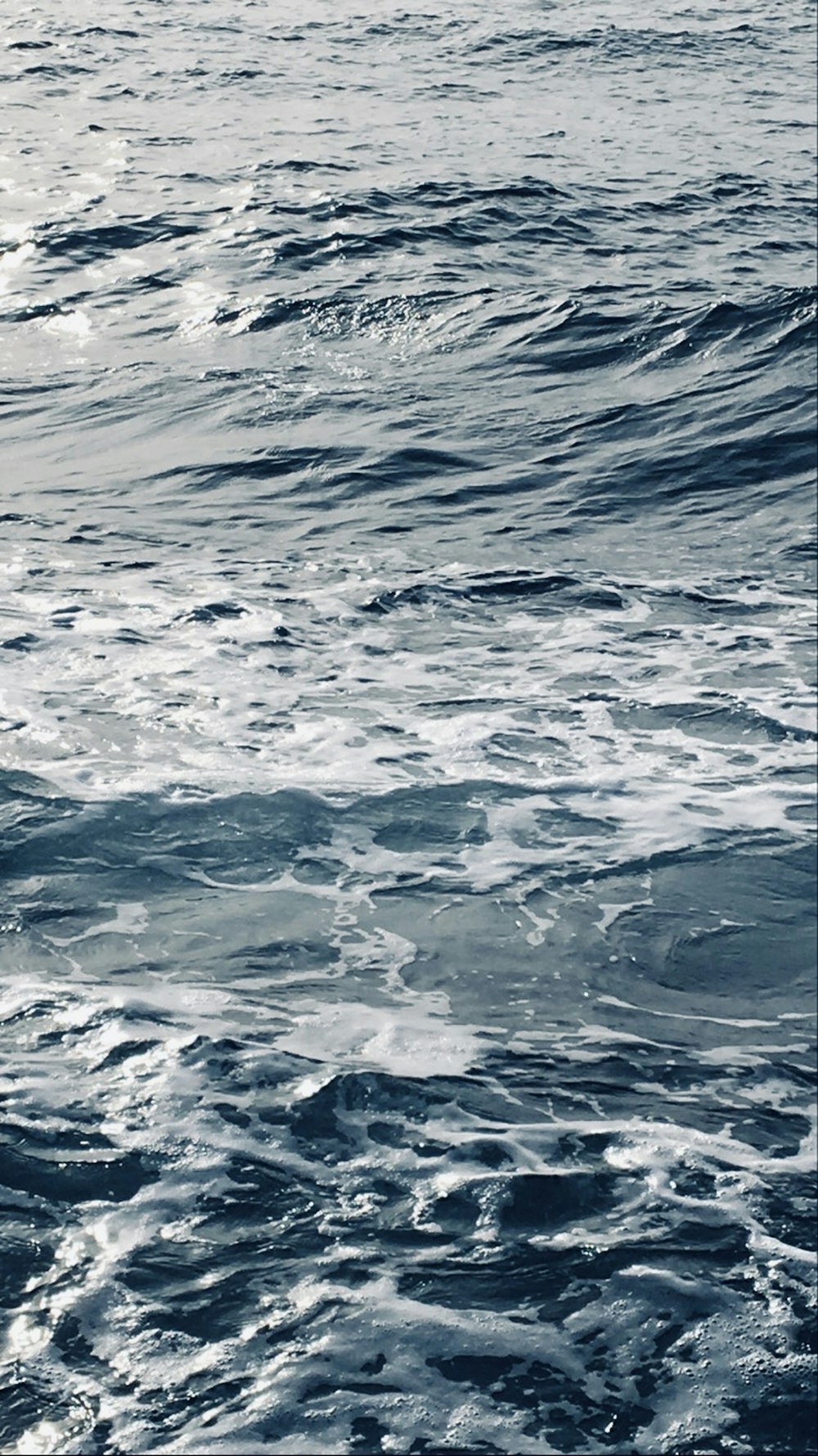 a man riding a surfboard on top of a wave in the ocean