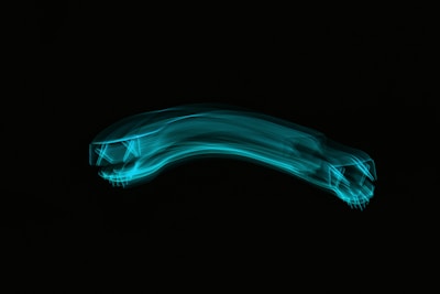 Neon blue interconnected nodes forming a delivery truck silhouette on dark navy.