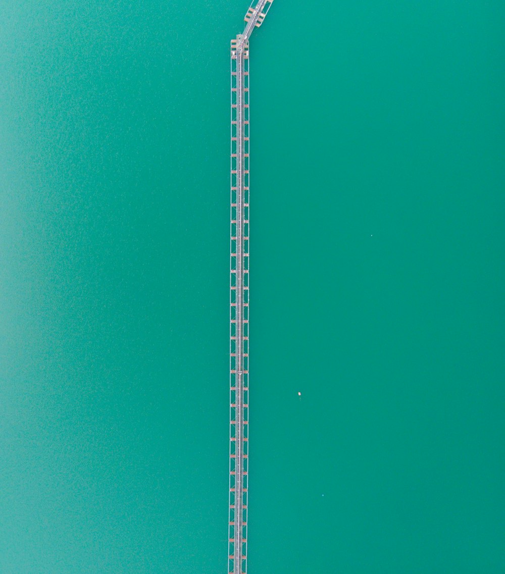 an aerial view of a water slide in the middle of a body of water