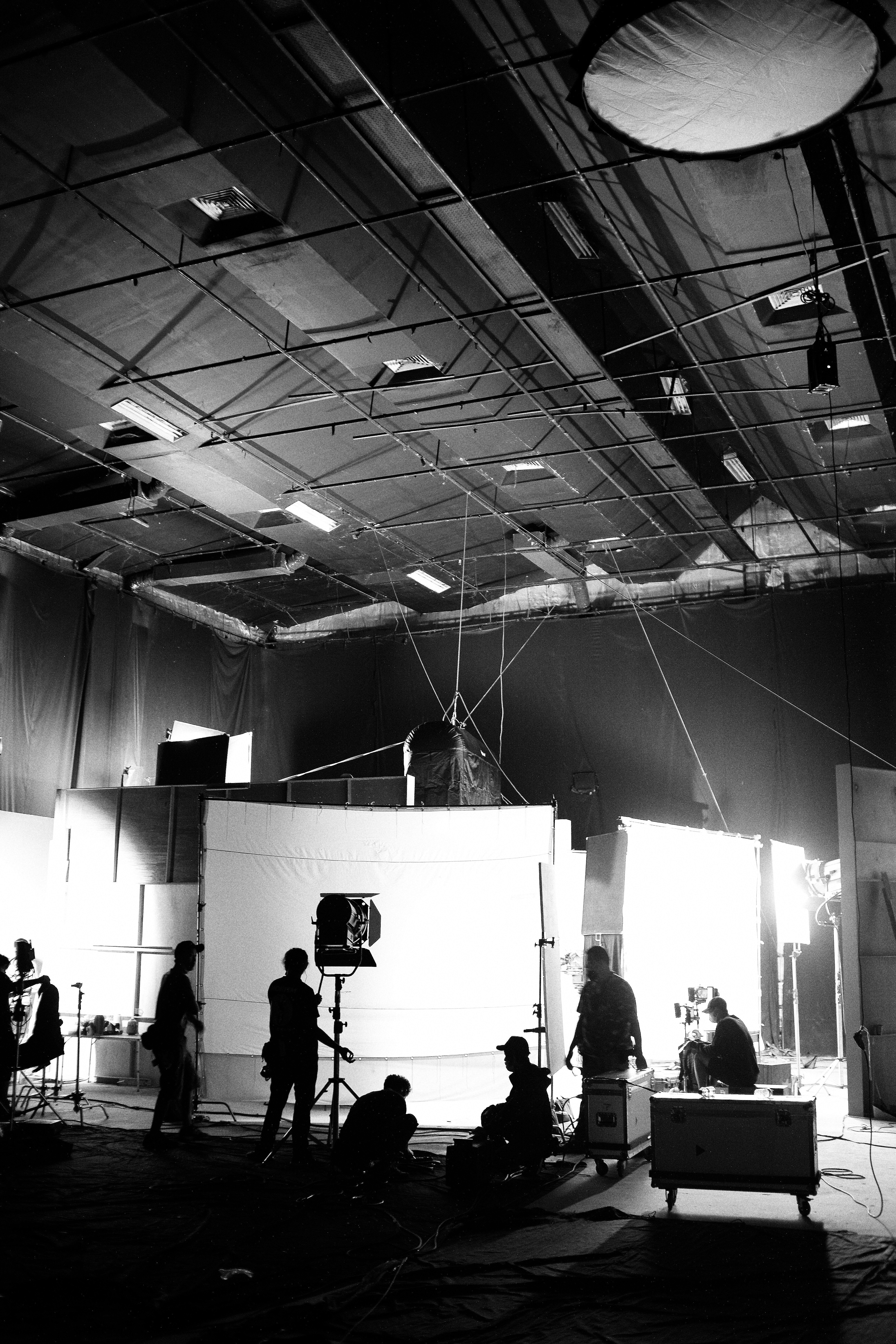 a black and white photo of people in a studio