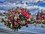 a bunch of flowers sitting on top of a car