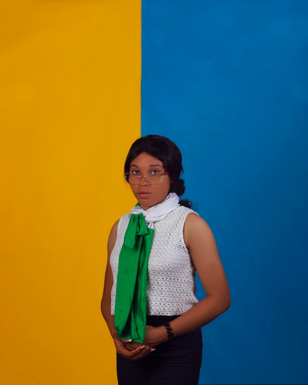 a woman standing in front of a yellow and blue wall