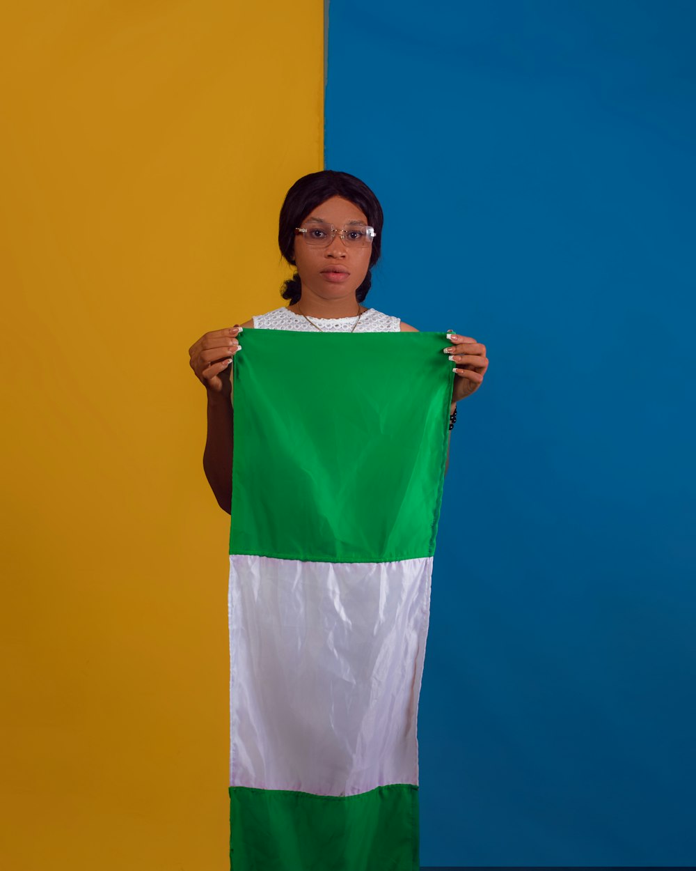 a woman holding a green and white flag