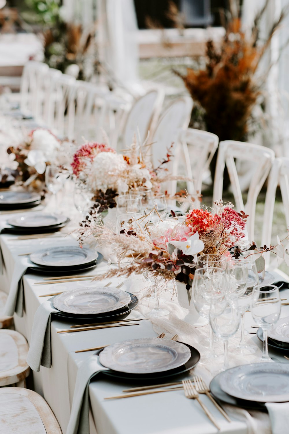 a long table with plates and place settings