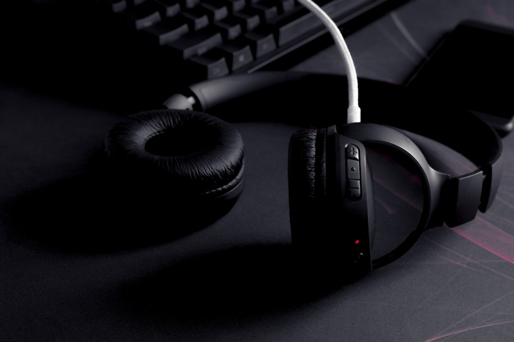 a pair of headphones sitting next to a keyboard