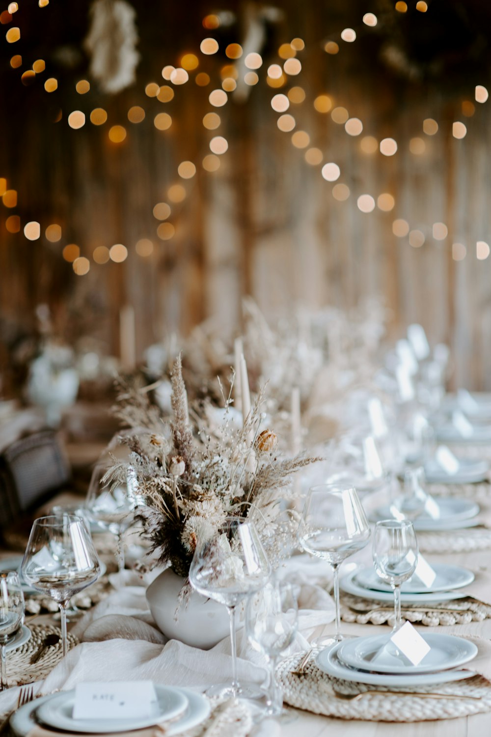 a table set with white plates and silverware