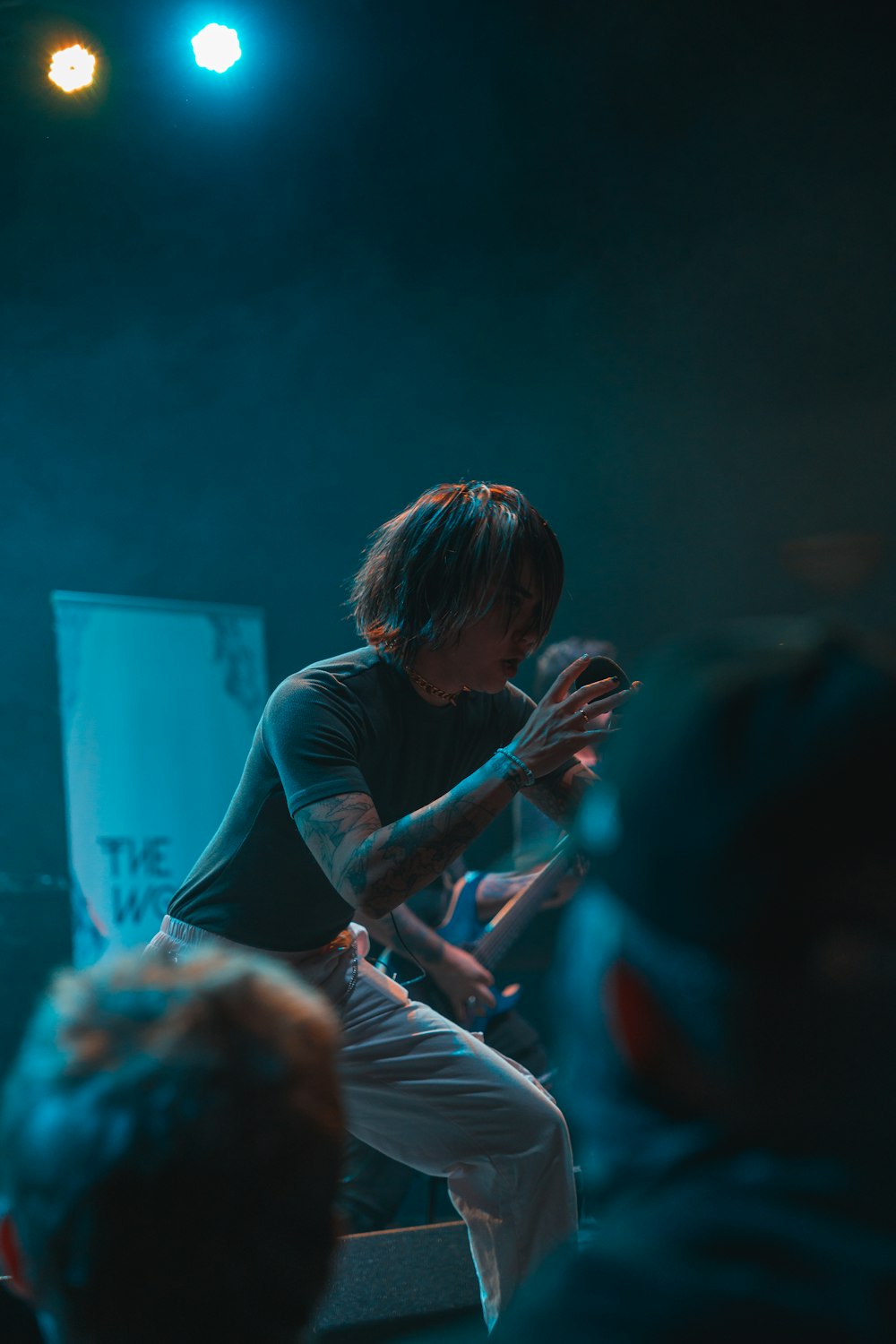 a man standing on top of a stage holding a microphone