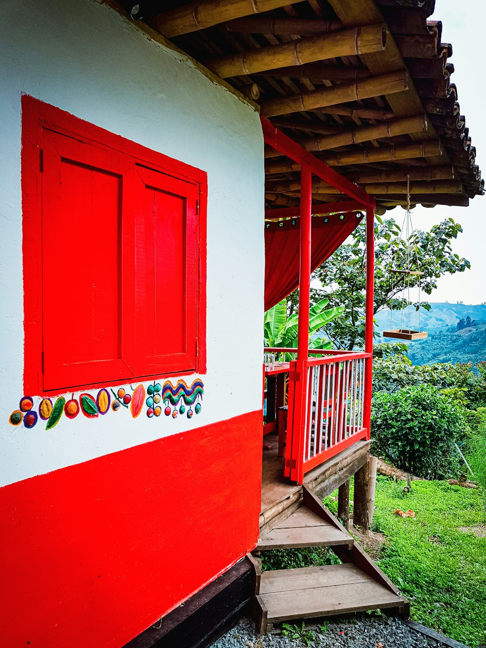 a red and white house with a red door