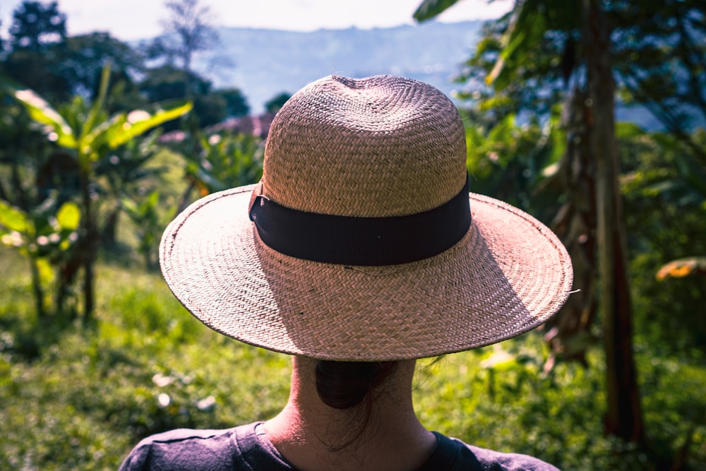 a woman wearing a straw hat in a field