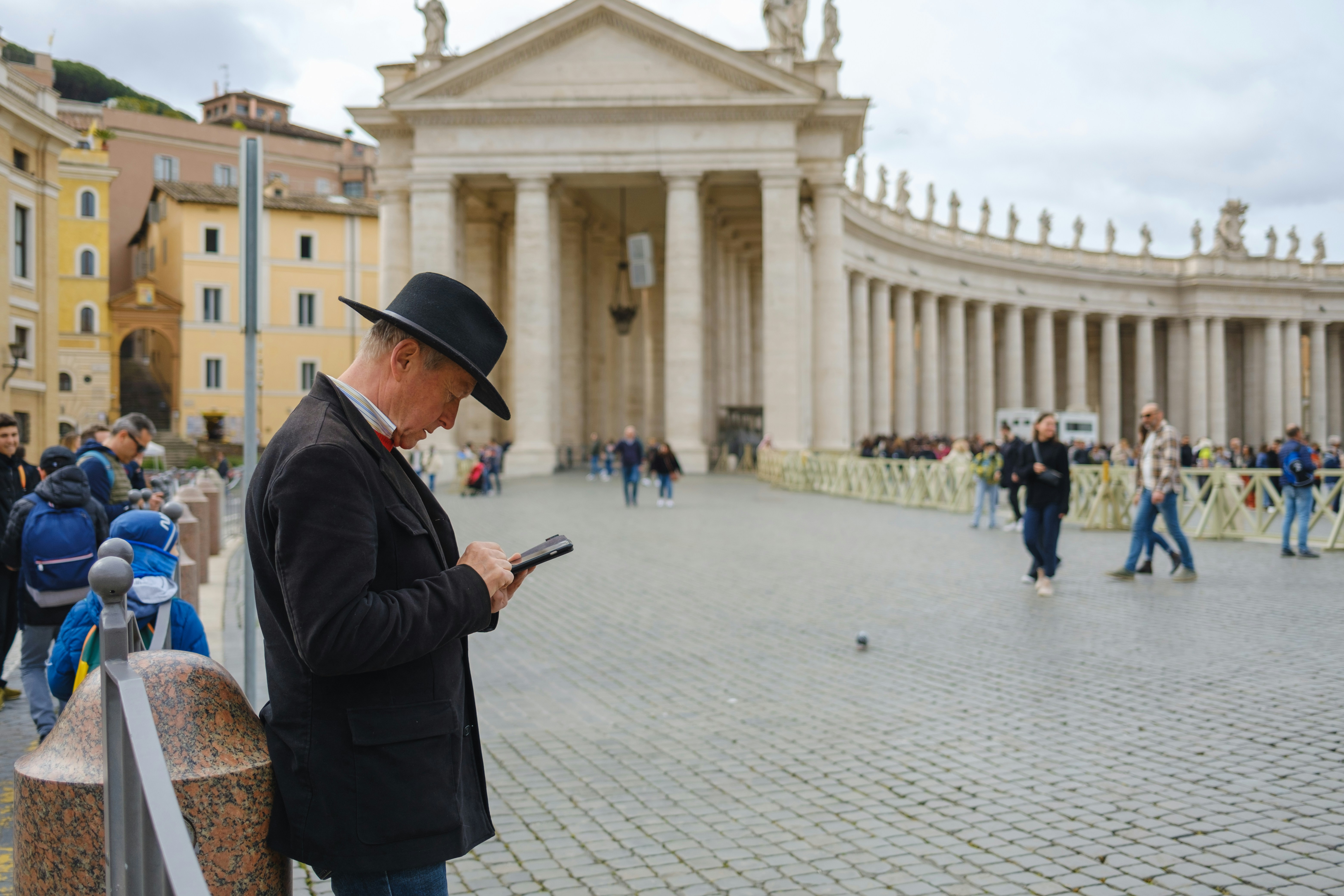 Traveler in Rome checking a smartphone for directions and connectivity