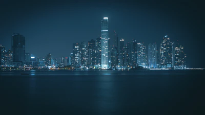 Nighttime city skyline with illuminated financial district buildings reflecting a sense of trust and stability.