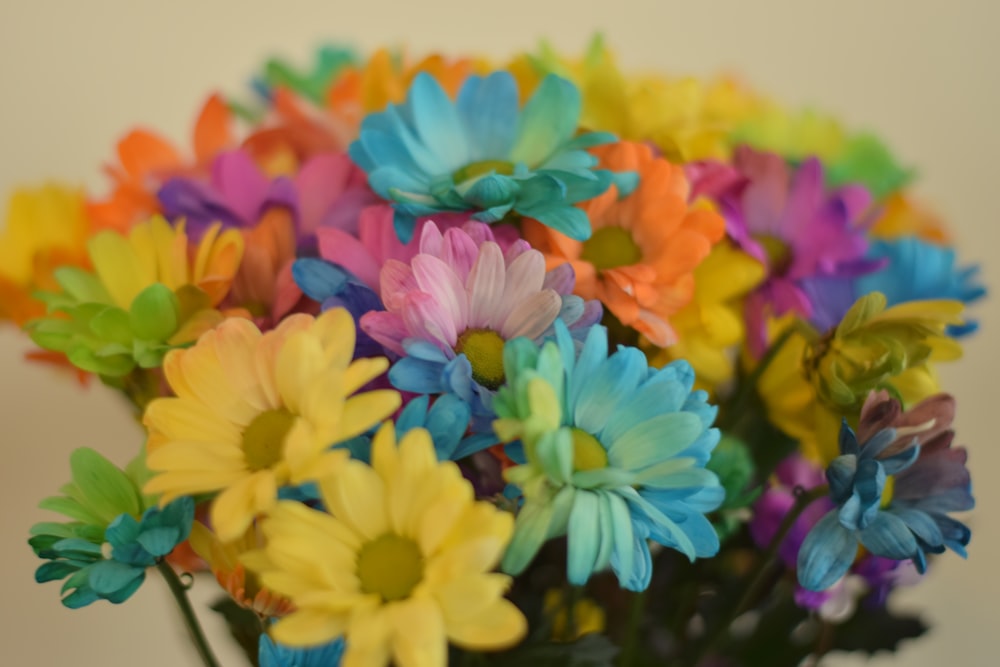 a vase filled with colorful flowers on top of a table