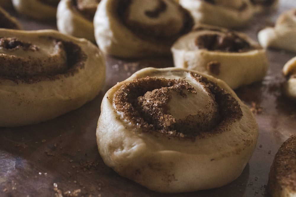 a close up of cinnamon rolls on a baking sheet