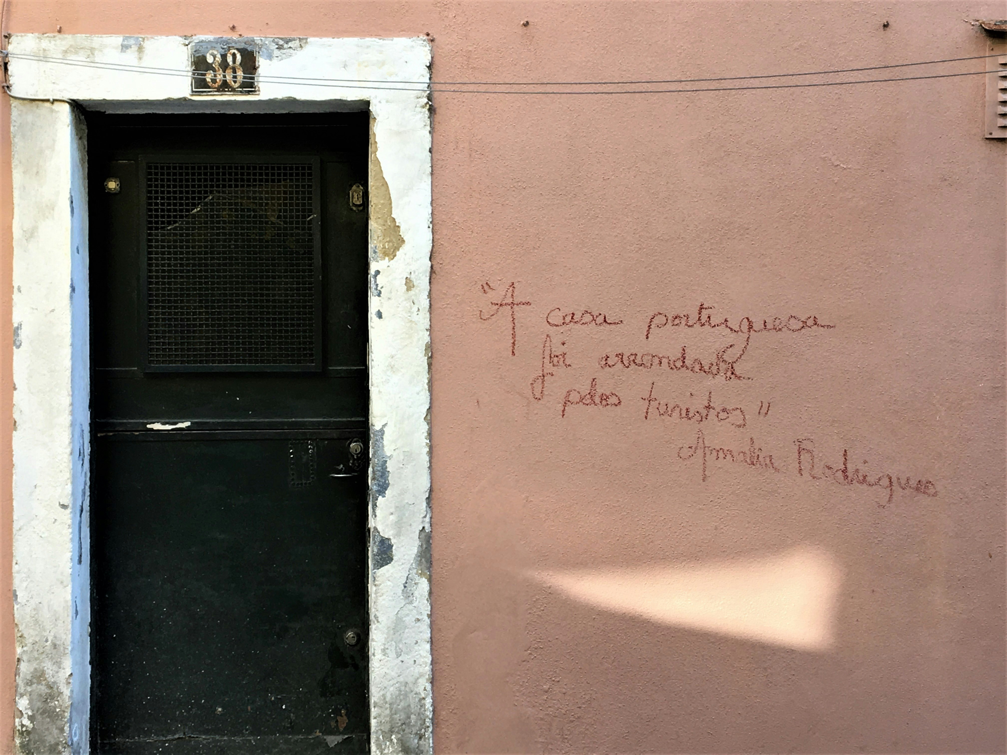 a door with graffiti on the side of a building