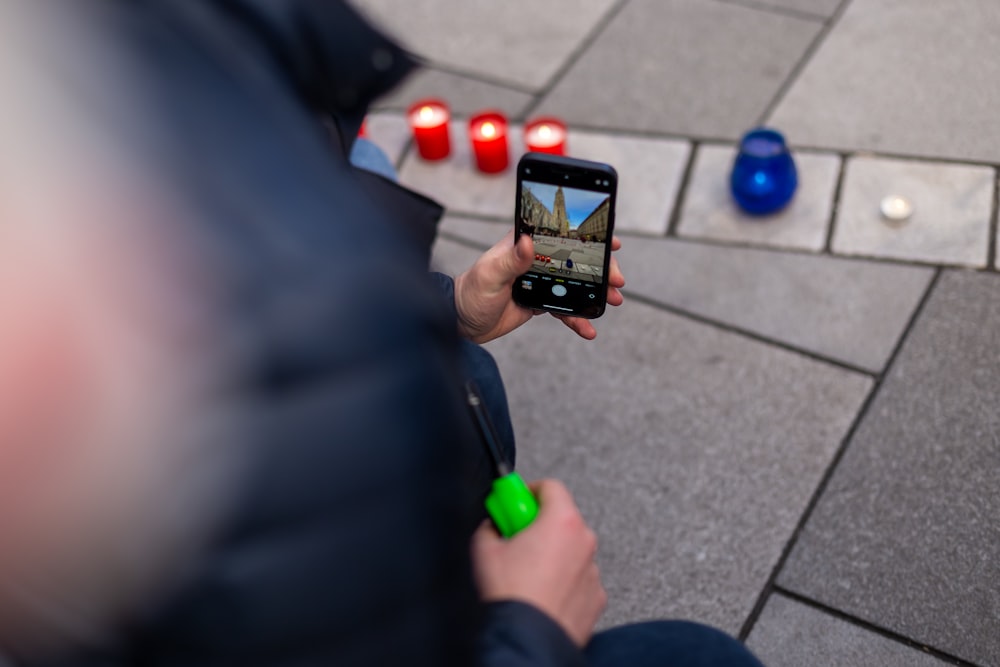 a person holding a cell phone in their hand