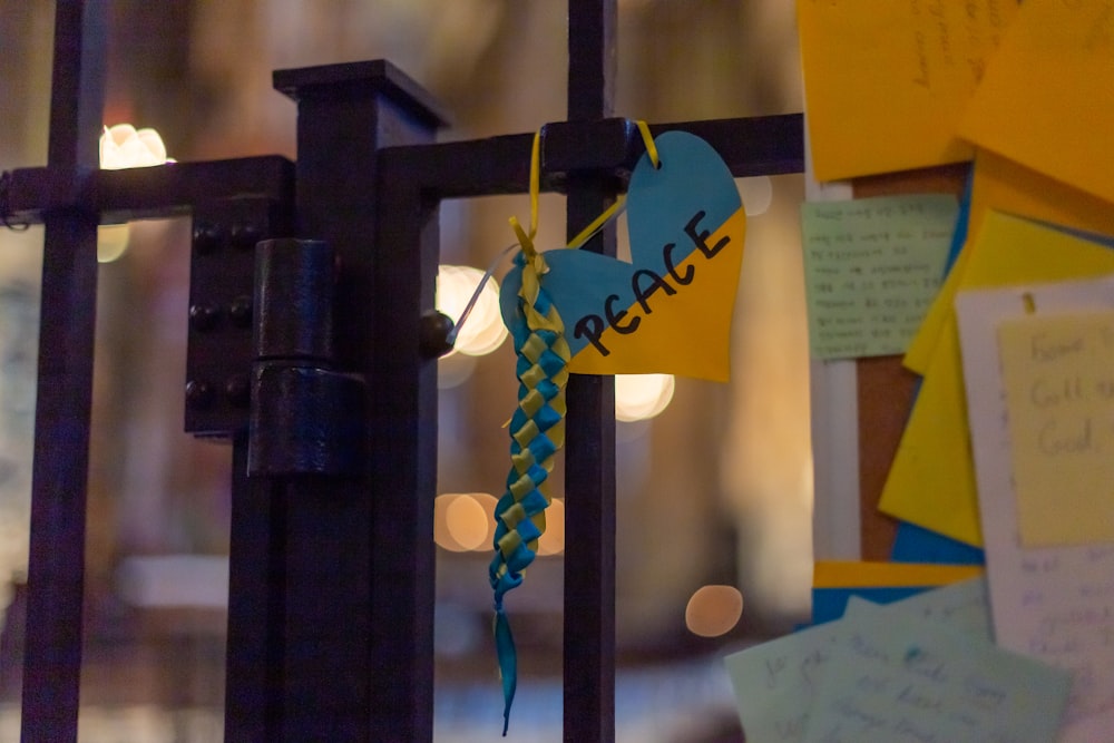 a close up of a fence with post it notes attached to it