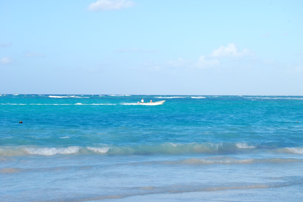 a boat is out in the ocean on a sunny day