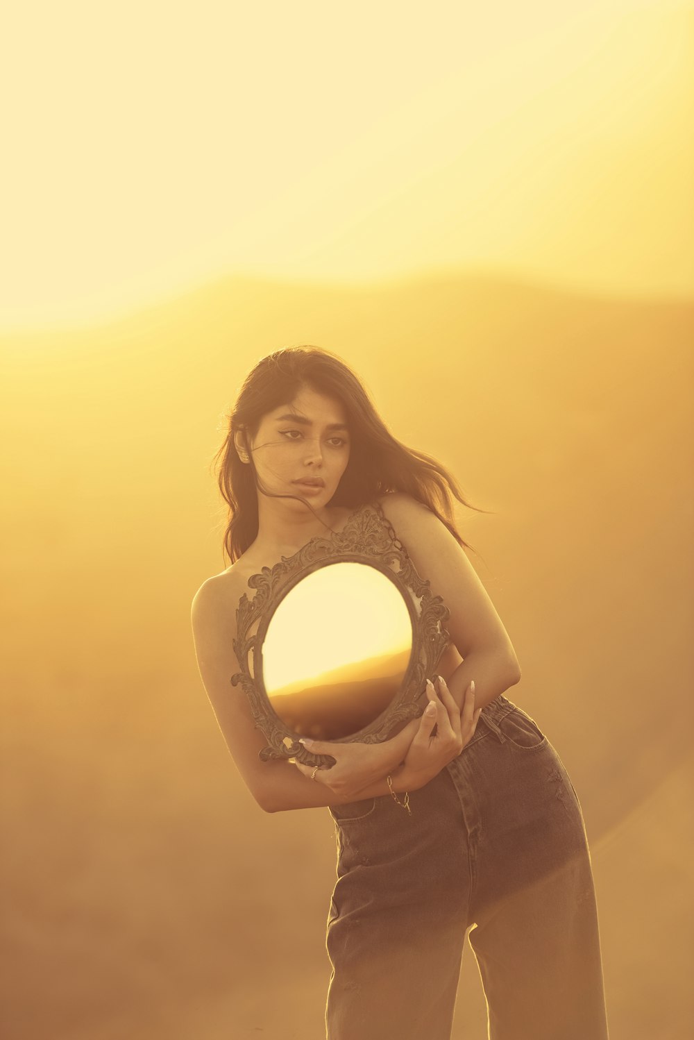 a woman holding a mirror in her hands