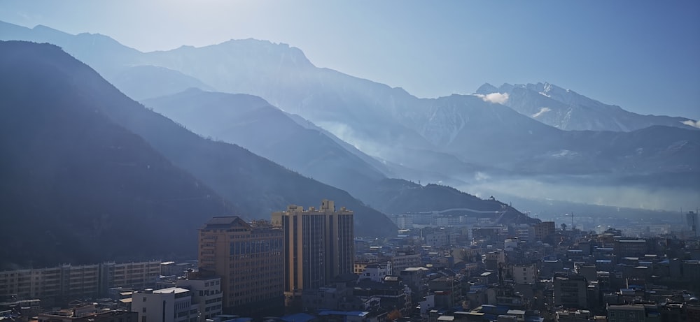 a view of a city with mountains in the background