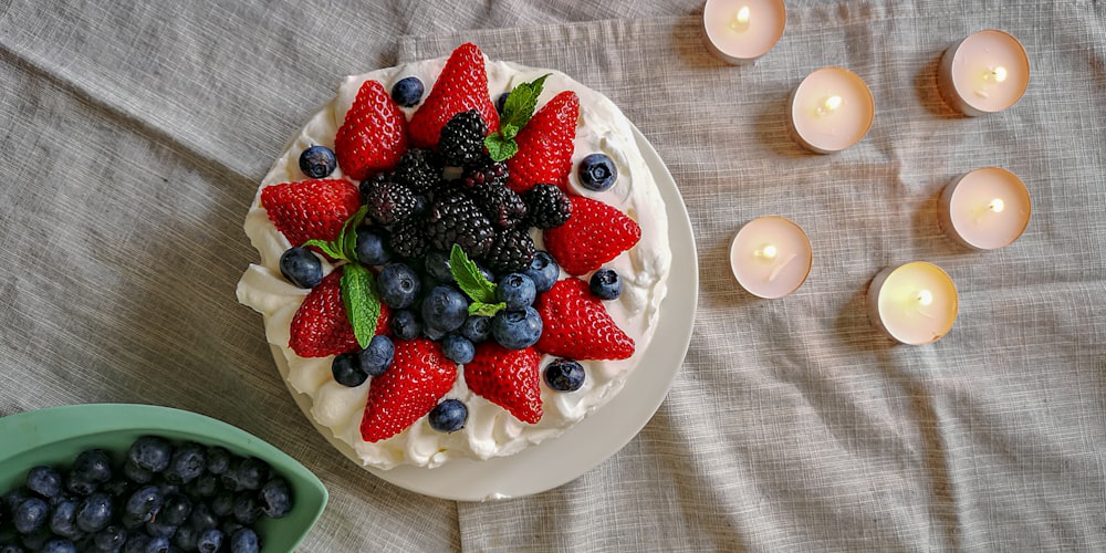 a cake with berries, blueberries, and raspberries on it