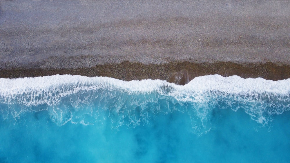 an aerial view of the ocean with waves