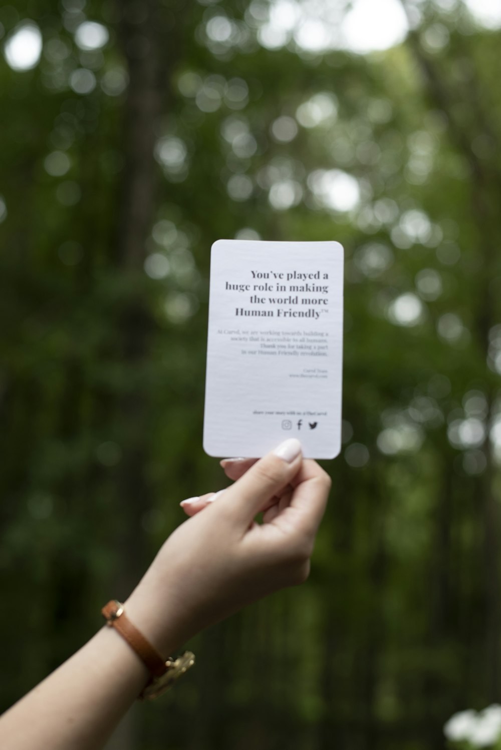 a person holding up a card with a quote on it