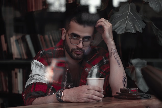 A calm, thoughtful person sitting at a desk surrounded by notes and a warm cup of tea, reflecting on a big decision.