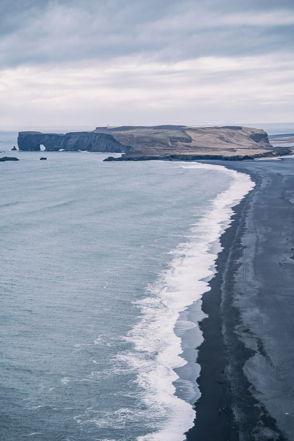 a large body of water sitting next to a sandy beach