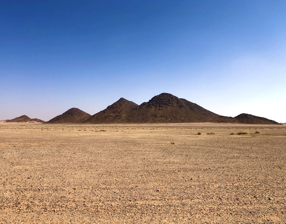 a group of mountains in the middle of a desert