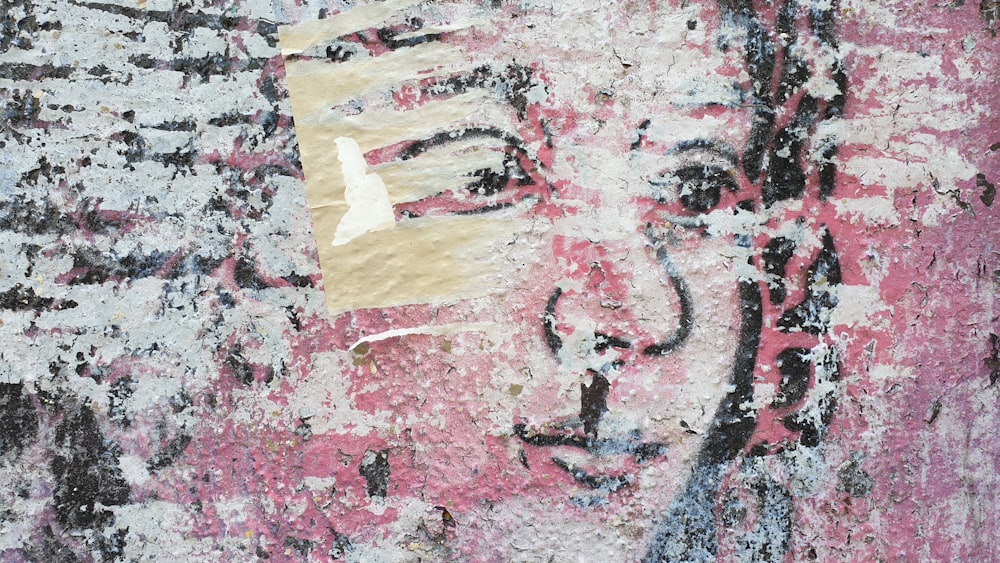 a painting of a woman's face on a wall