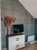a flat screen tv sitting on top of a dresser