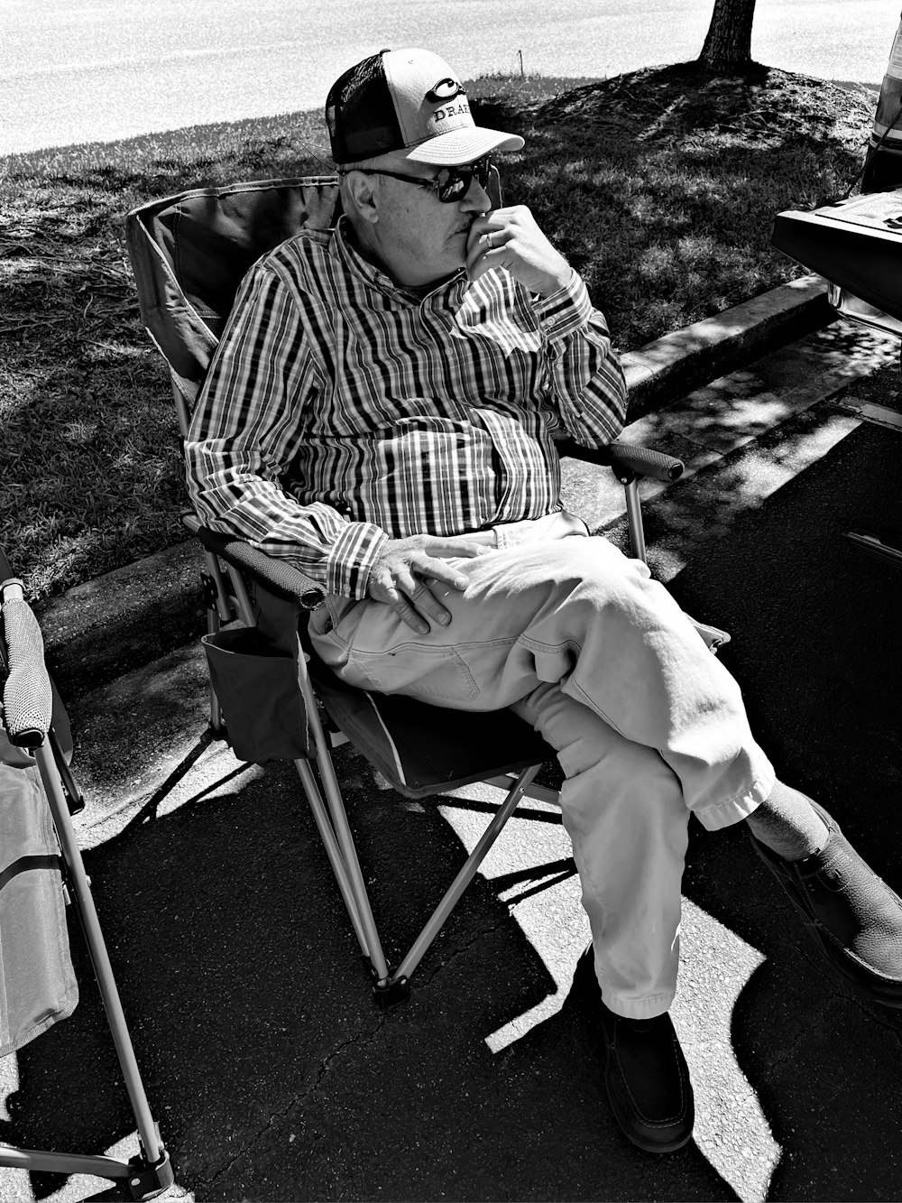 a black and white photo of a man sitting in a chair