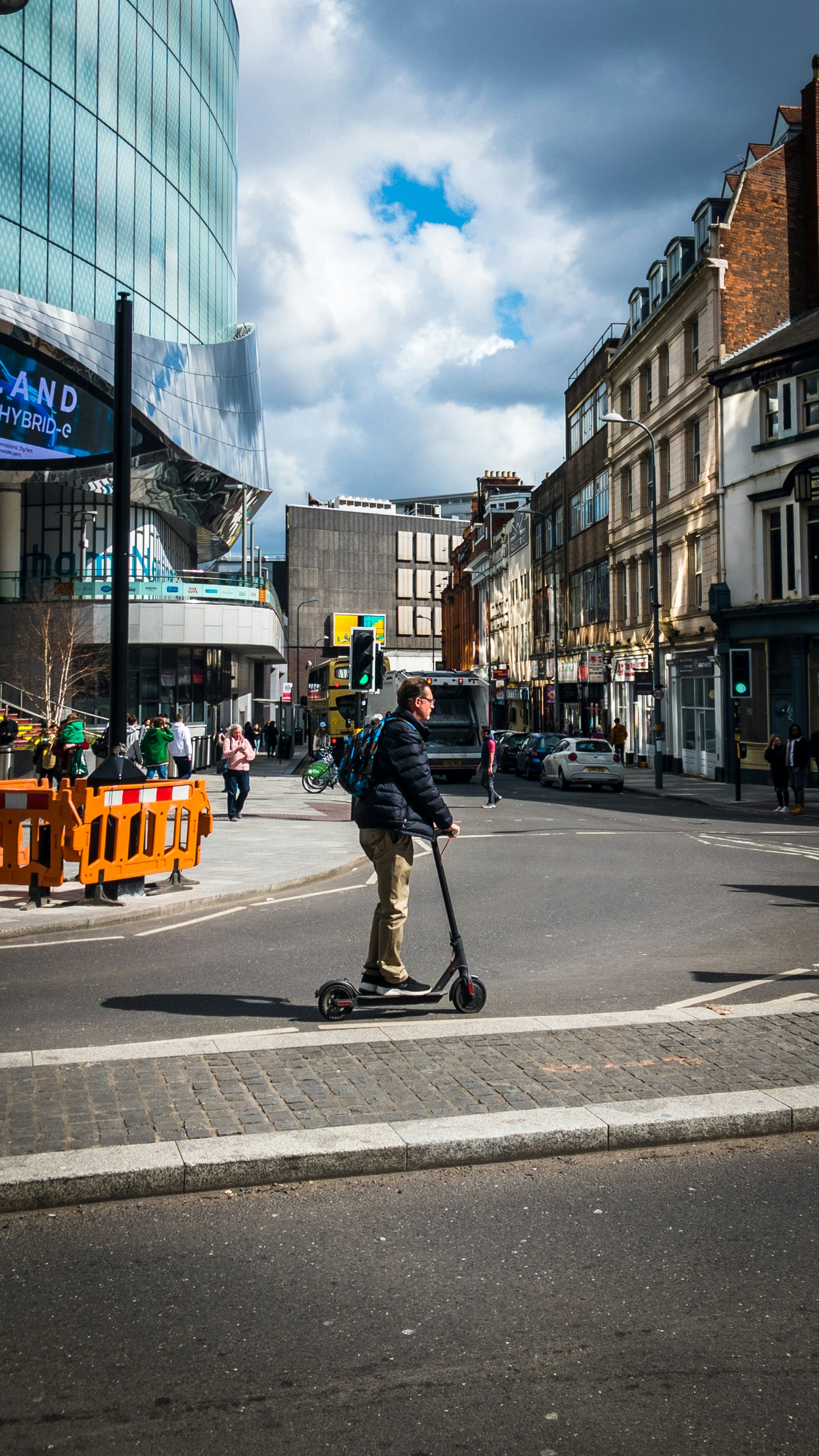a man riding a scooter on a city street