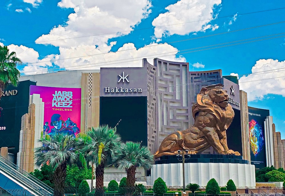 a large golden lion statue sitting in front of a building