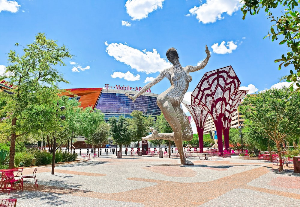 a statue of a woman dancing in front of a building