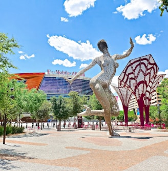 a statue of a woman dancing in front of a building