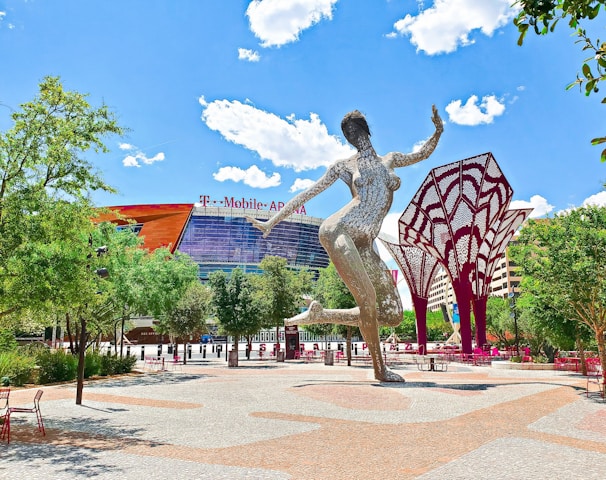 a statue of a woman dancing in front of a building