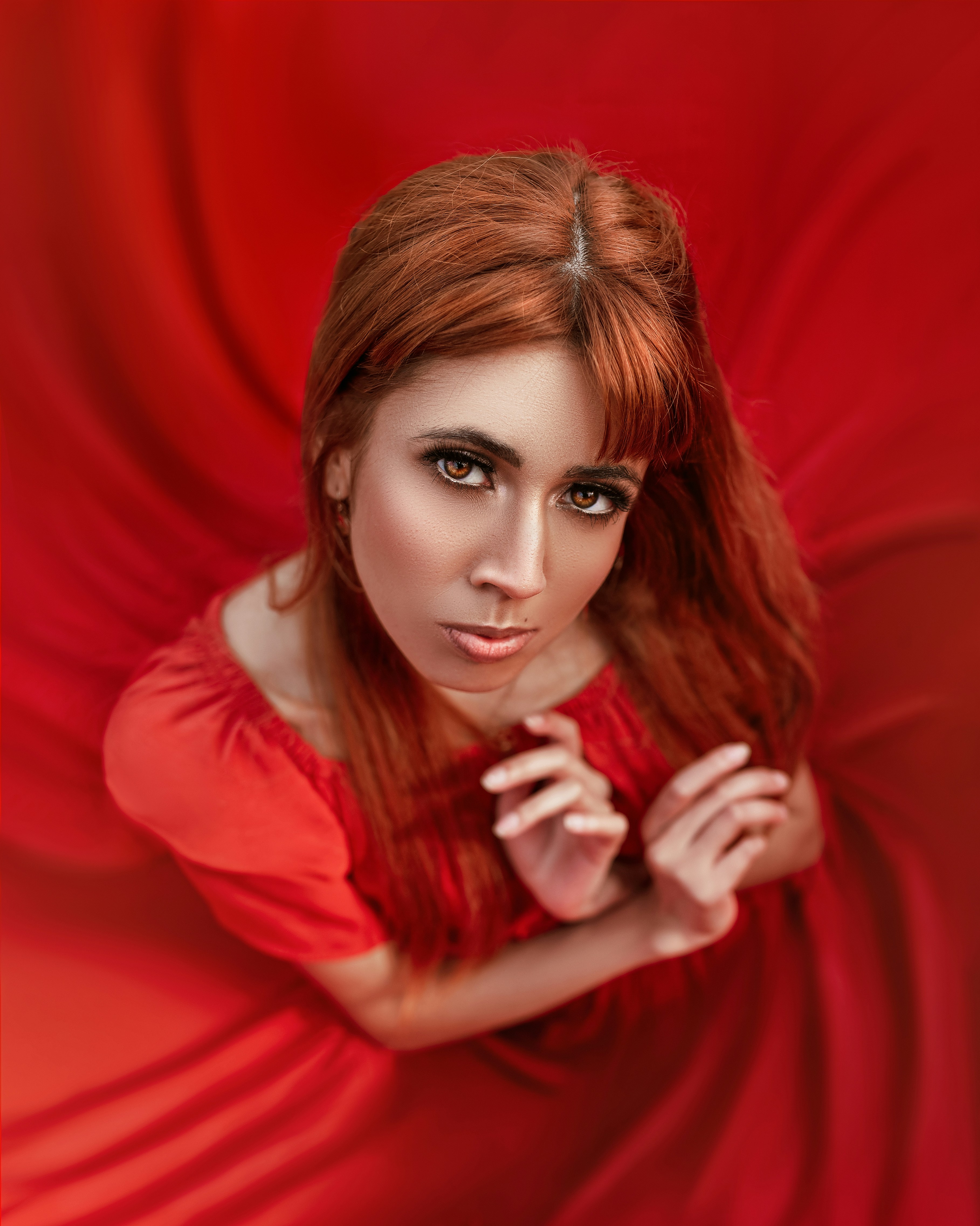 A woman in a red dress posing for a picture photo – Free Red Image on ...