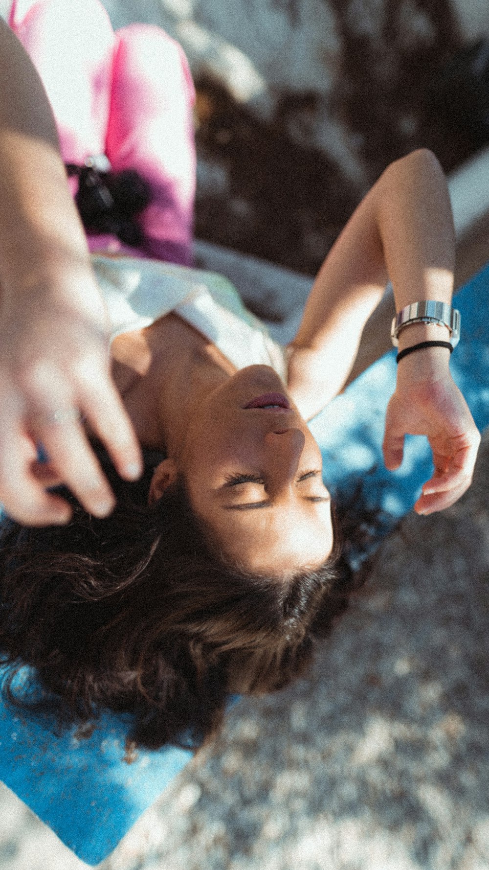 a woman laying on the ground with her hand on her head