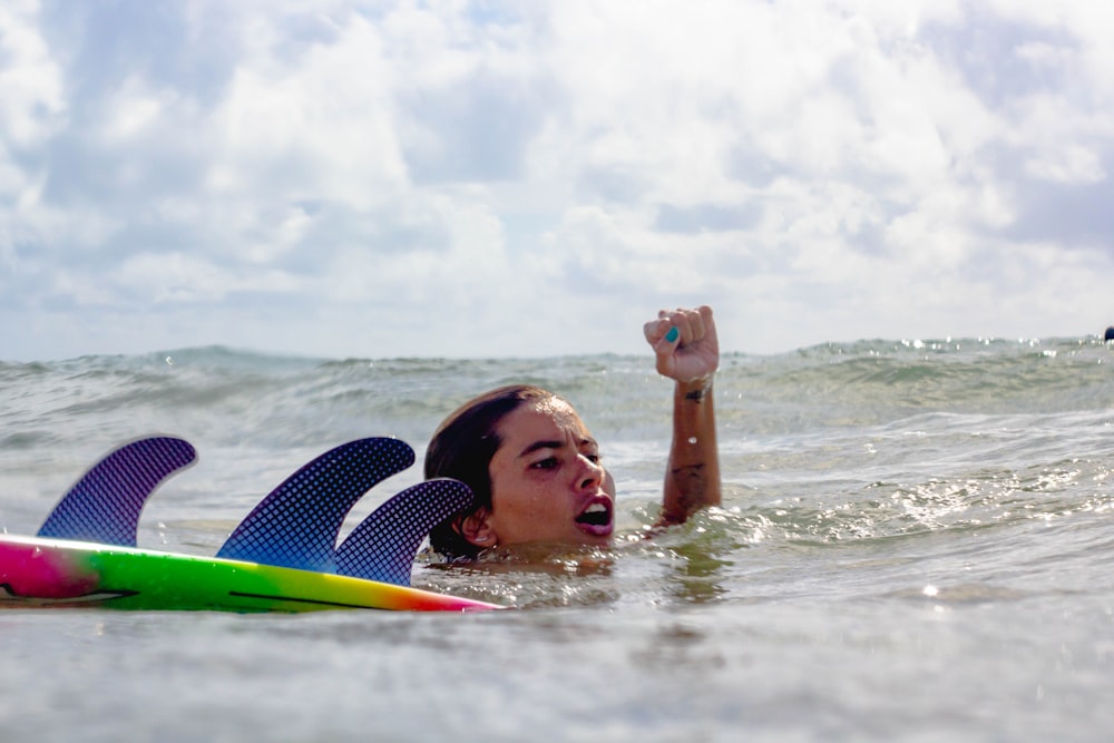 a woman in the water with a surfboard