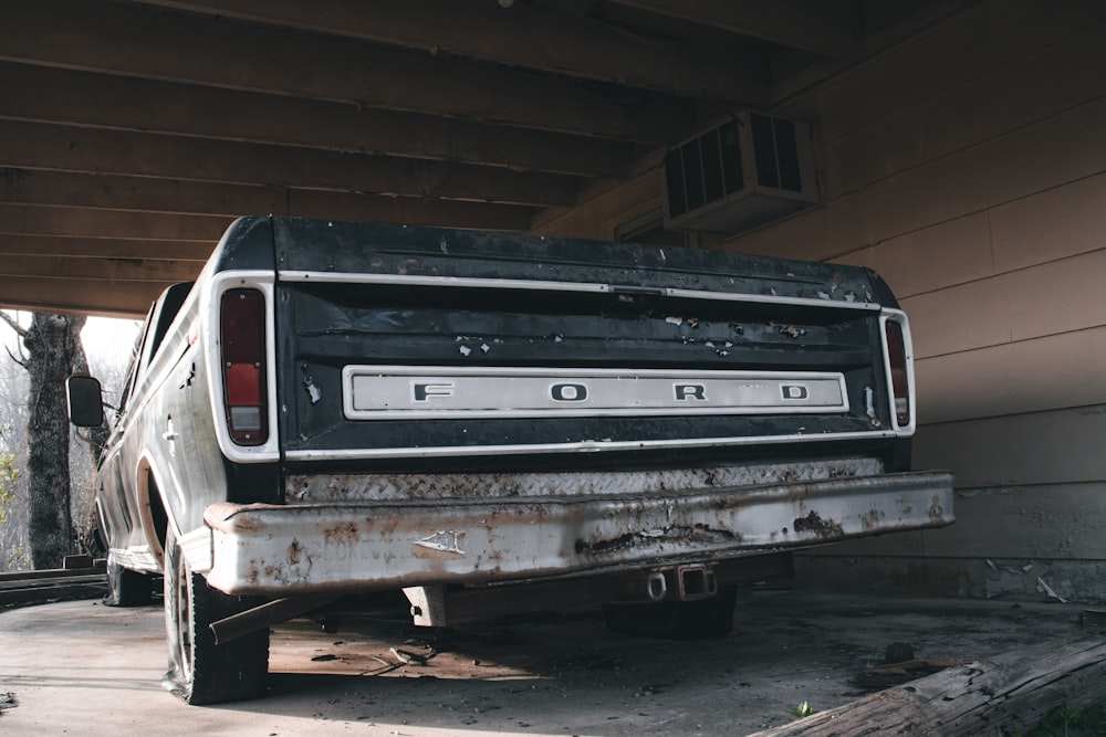 an old ford truck parked in a garage