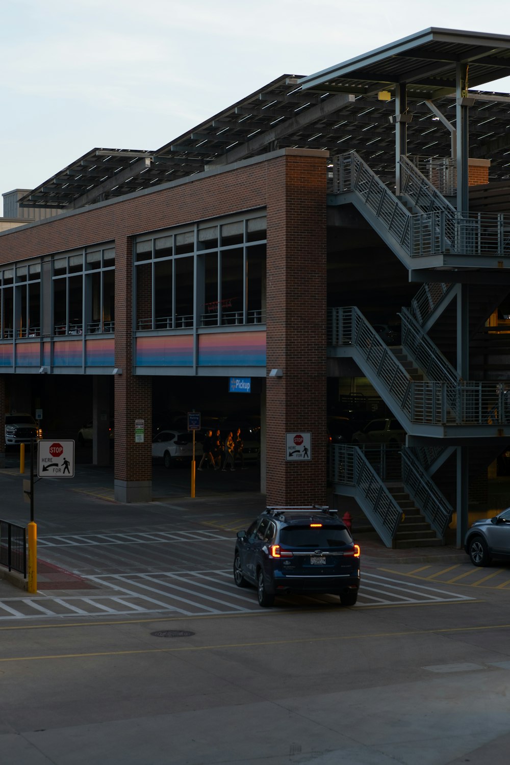 a car is parked in front of a parking garage