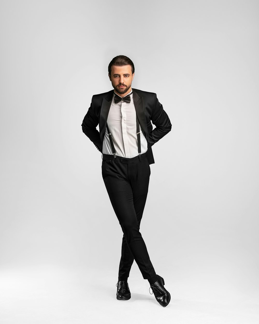 a man in a tuxedo posing for a picture
