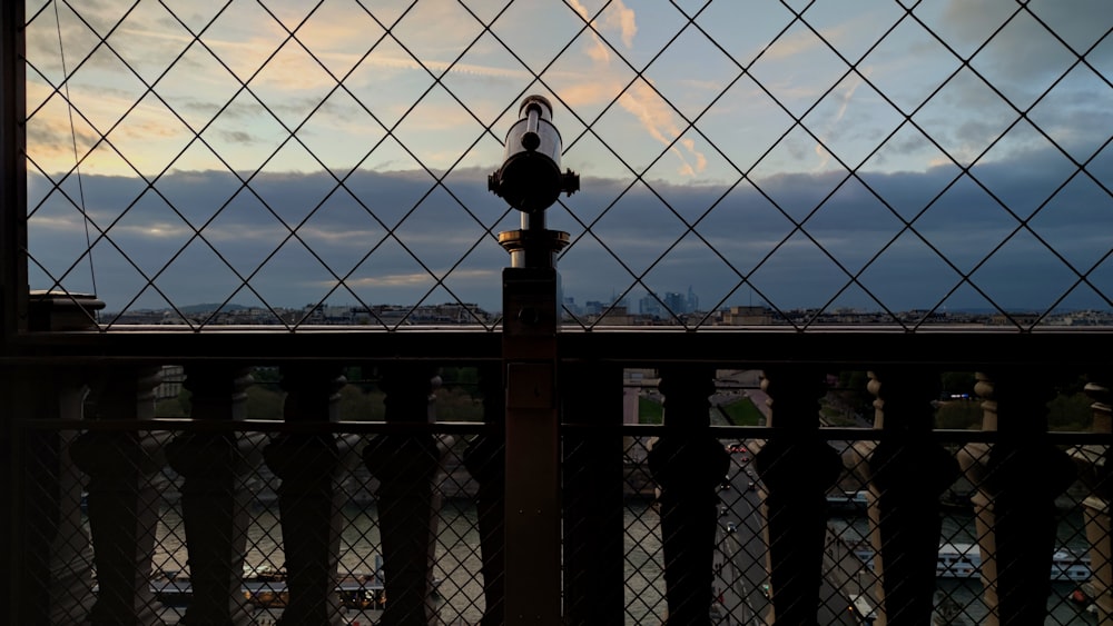 a view of a city through a chain link fence