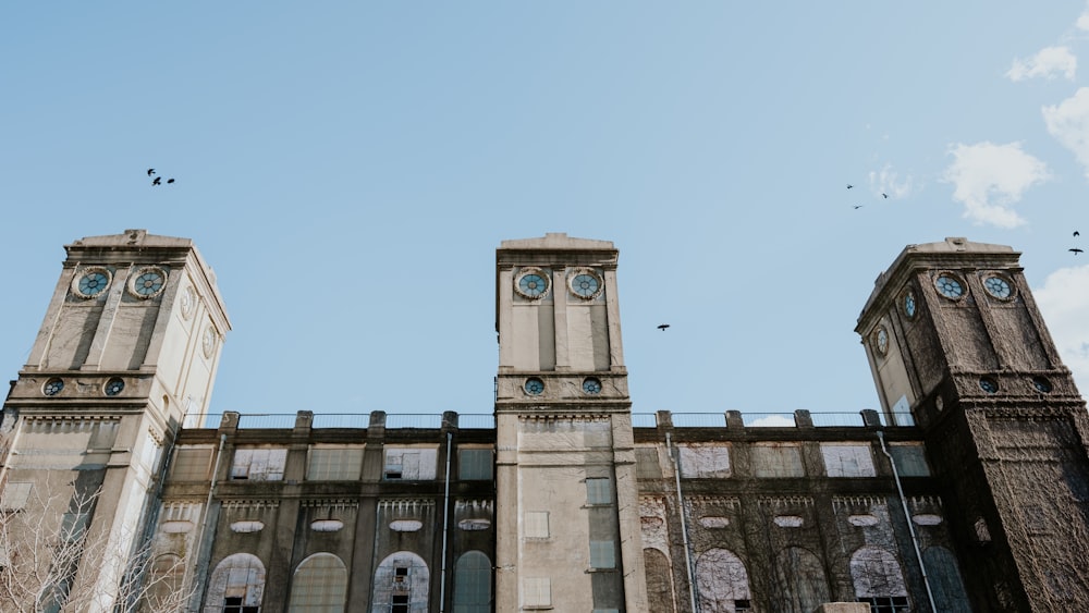 a tall building with two clocks on each of it's sides