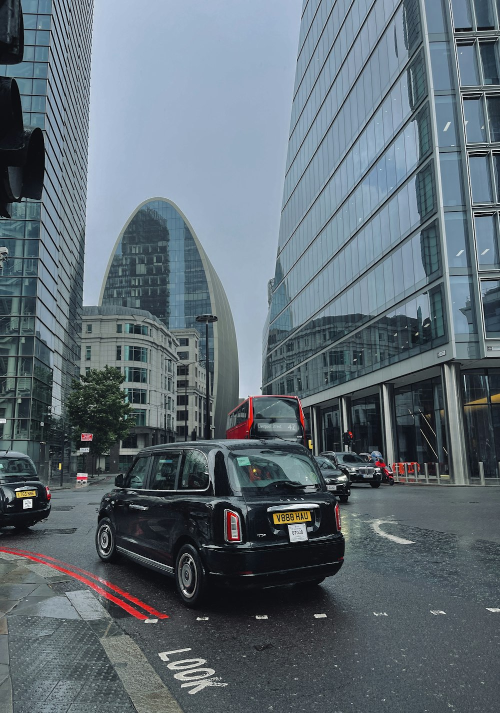 a city street filled with traffic next to tall buildings