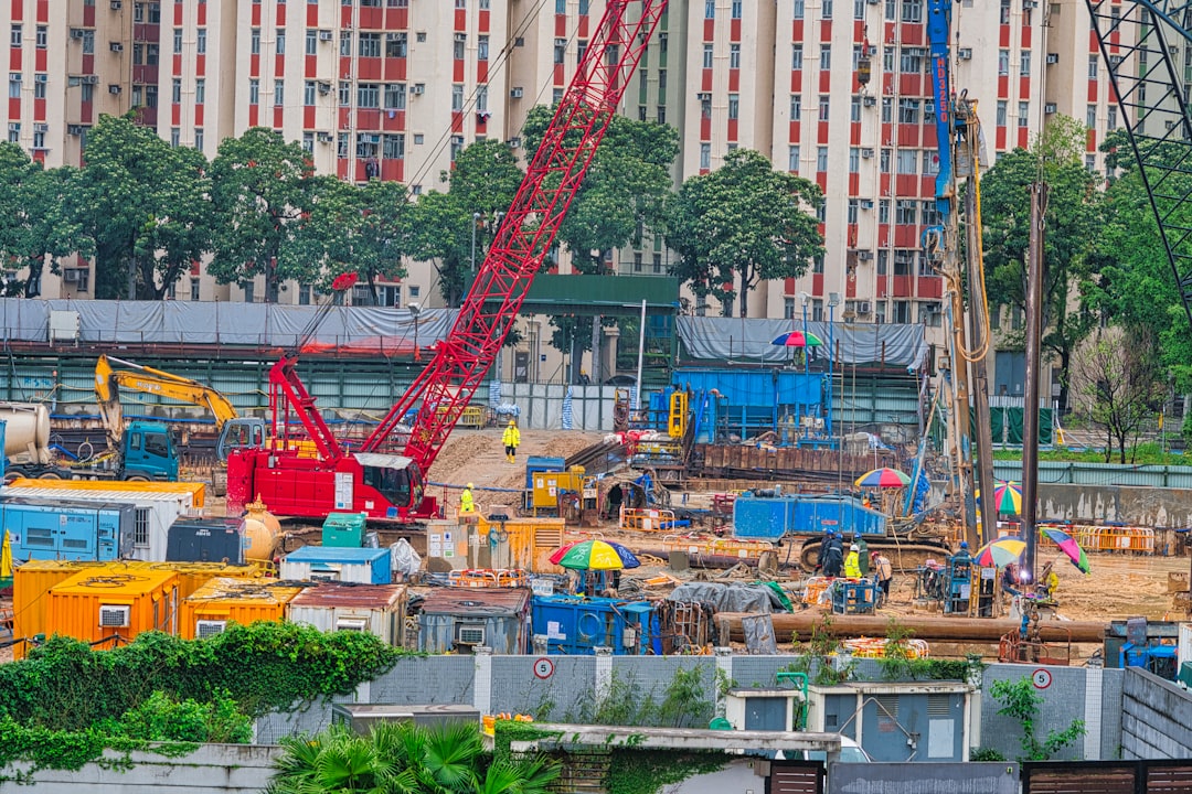 a construction site with a crane in the middle of it,